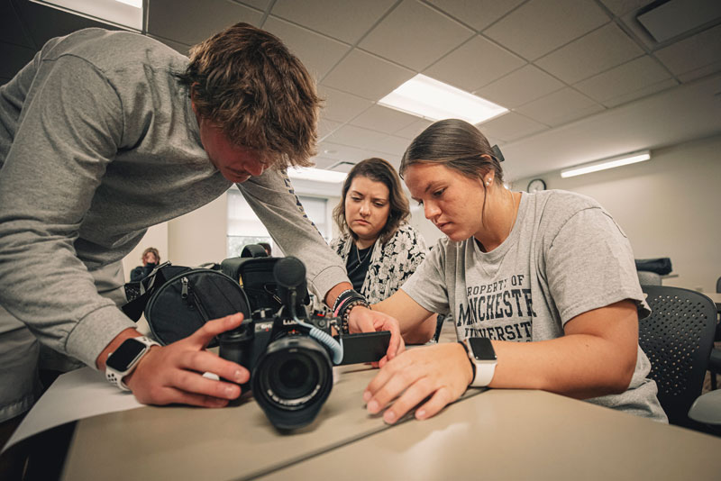 MU students enrolled in Communications Programs work together with a camera.