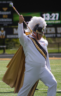 Drum major takes the field during a Homecoming performance