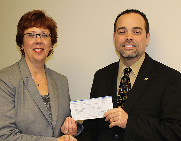 Walgreens representative Randy Jennings presents Dr. Raylene Rospond, MU vice president and dean of the MU College of Pharmacy, Natural and Health Sciences, with a Walgreens Diversity Donation of $8,000.