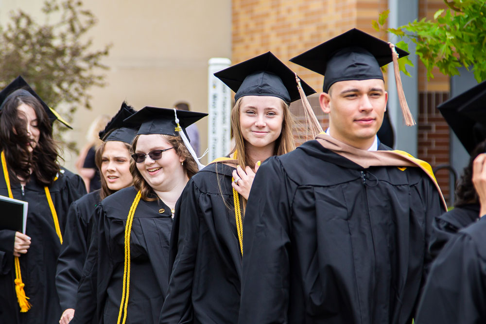 Students walk to receive their undergrad diploma. A time honored tradition before the ceremony.