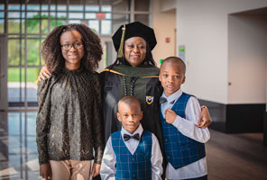 image shows student and family from the MU hooding ceremony