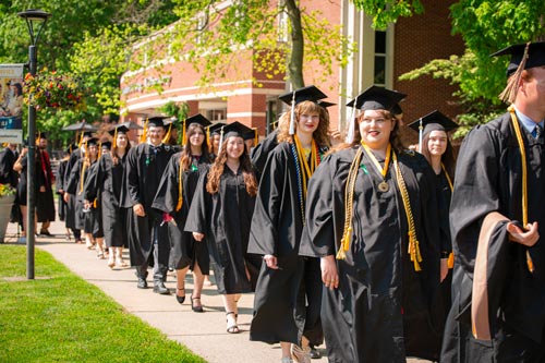 Graduating students walking by Funderberg library