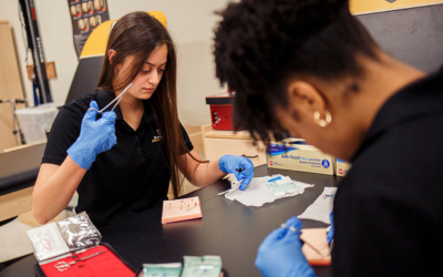 Image of student practicing healing a wound.