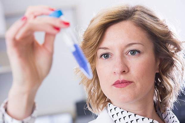 Diane Calinski, assistant professor of pharmaceutical sciences, demonstrates techniques used in pharmacogenomics.